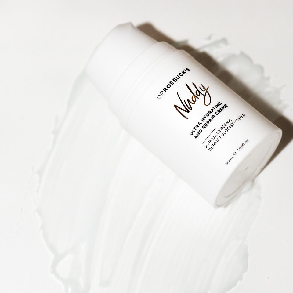Dr Roebuck's Nuddy Ultra Hydrating and Repair Creme bottle with product showing texture on white background.